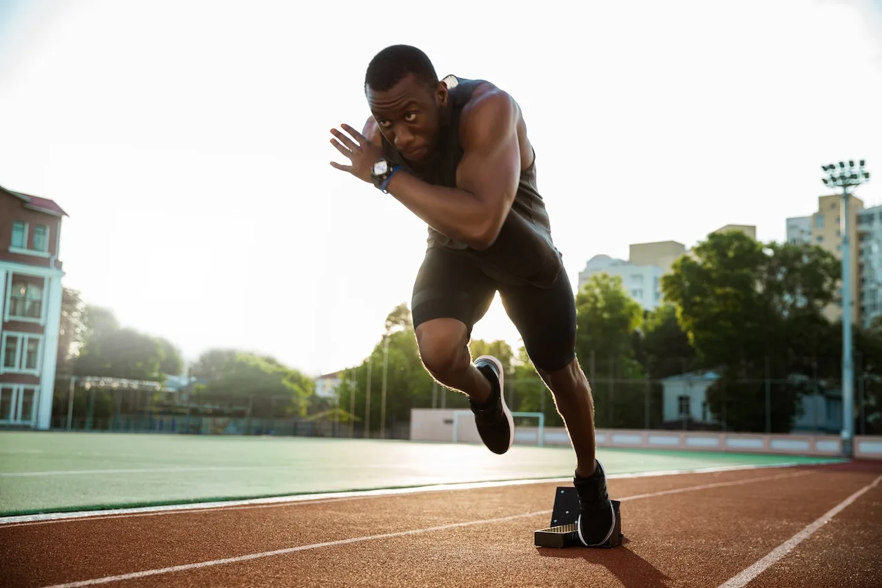 Athlete in starting position on running track